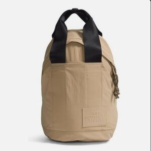 THE NORTH FACE Women's Never Stop Mini Backpack, Kelp Tan/TNF Black
